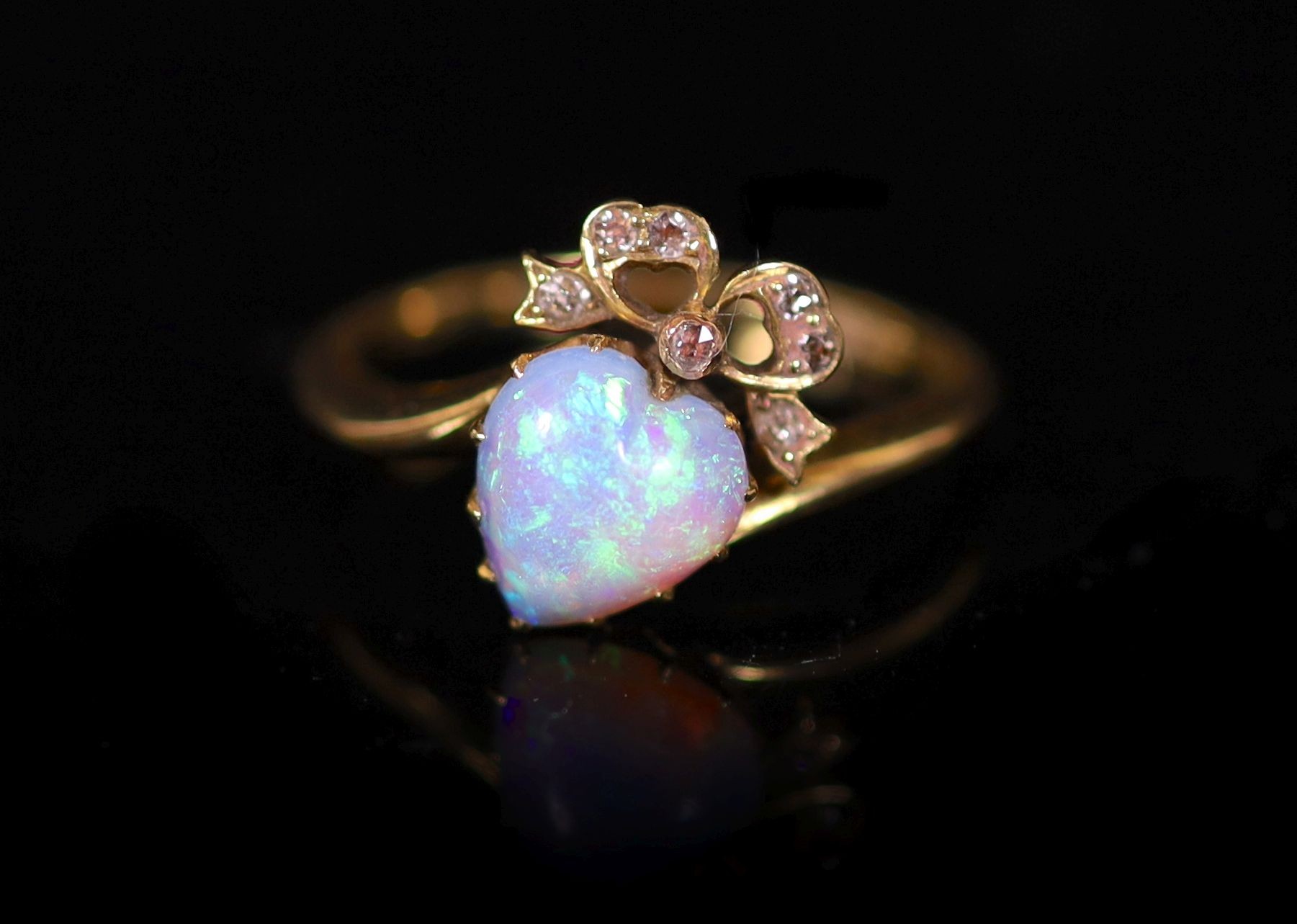 A late Victorian gold, heart shaped opal and diamond set crossover ring